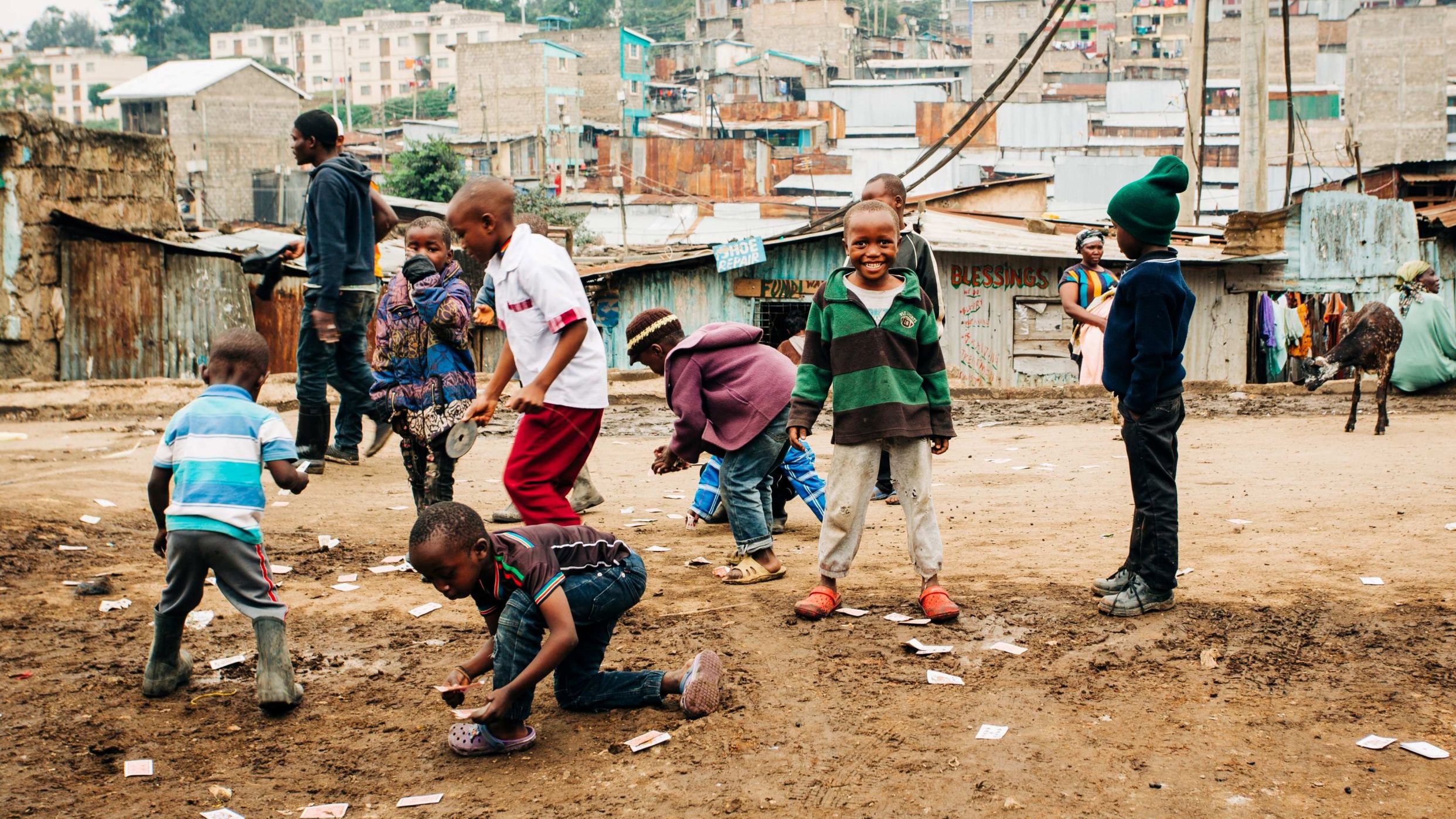 a group of children playing in a dry field